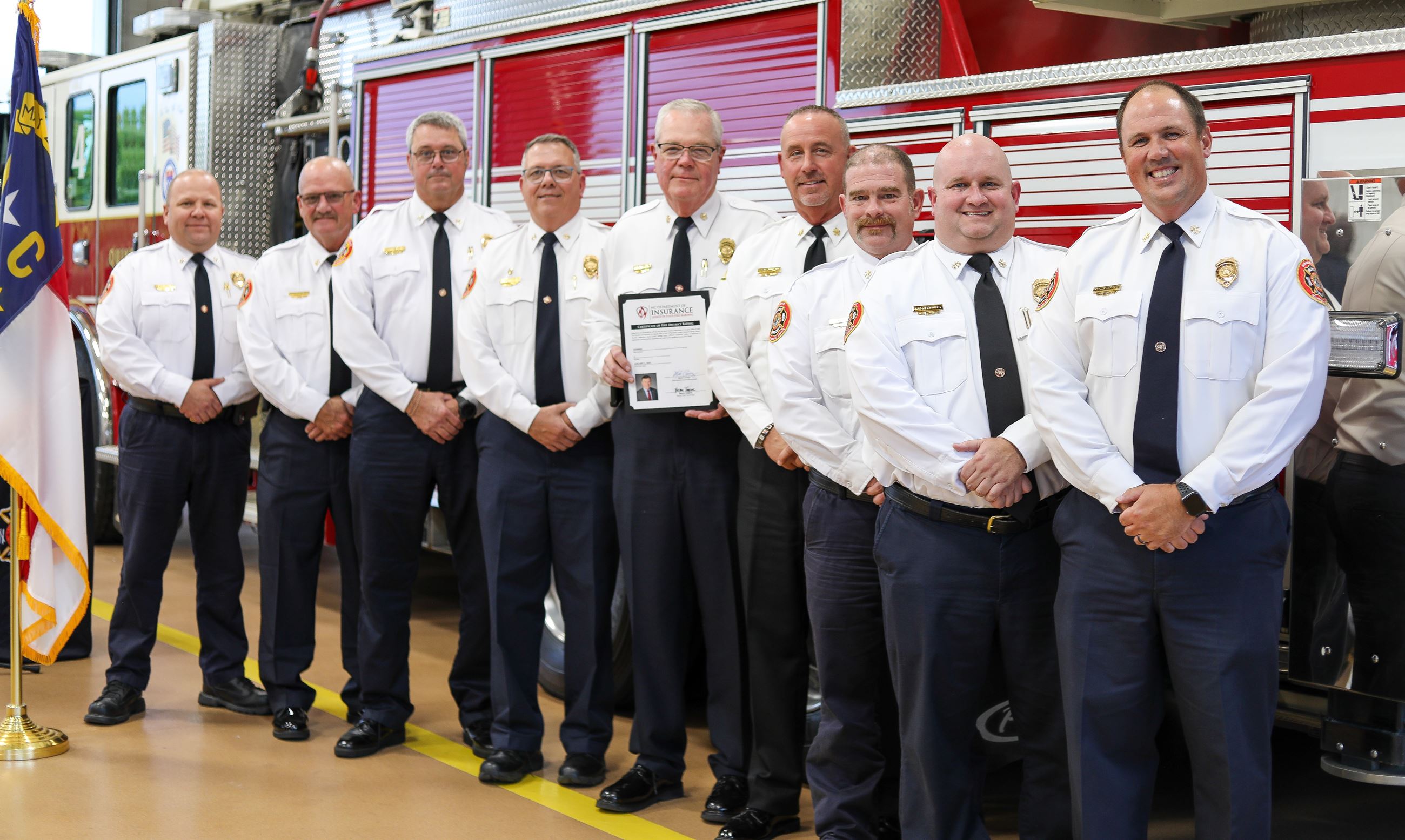 Monroe Fire Chiefs with North Carolina Fire Marshal Chief Brian Taylor in front of firetruck